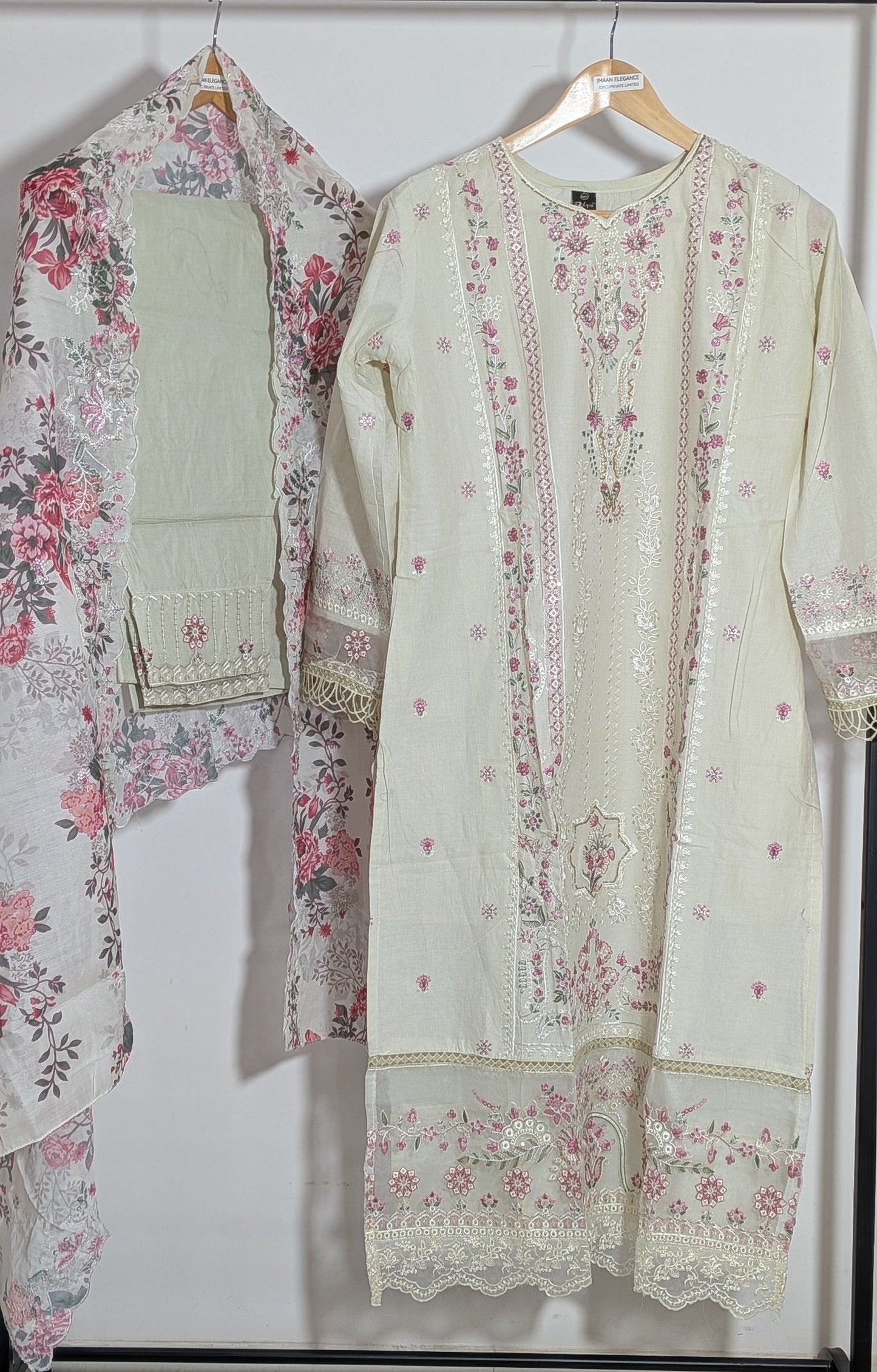 Light-colored embroidered outfit with floral patterns on a white background